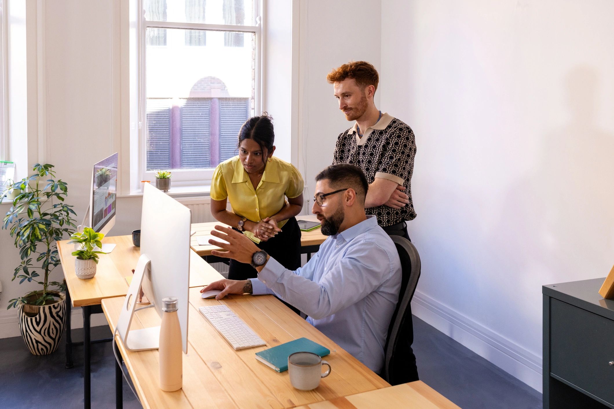 Small software team collaborating around a computer